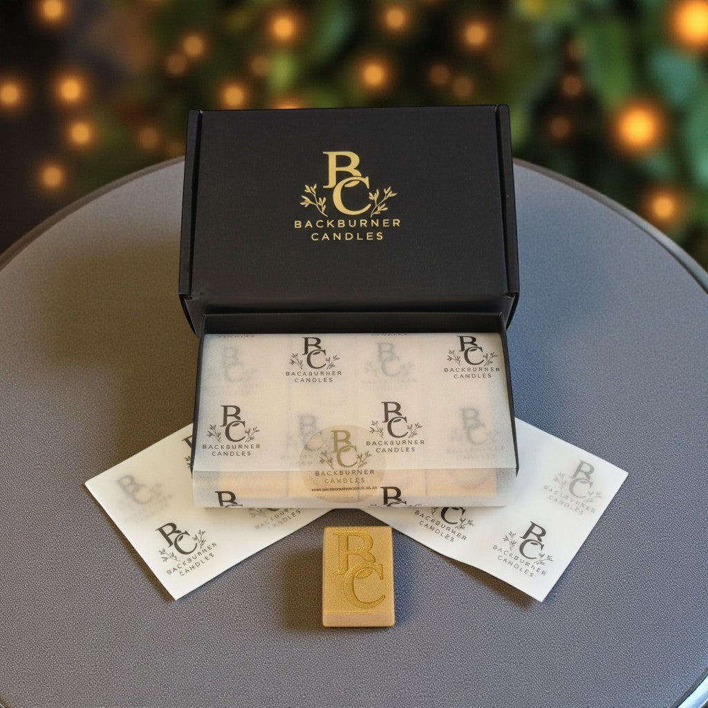 Backburner Candles wax melt gift box with branded wrap and gold melt, styled for premium display