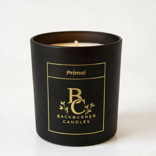 Black candle with gold logo and text on a white background