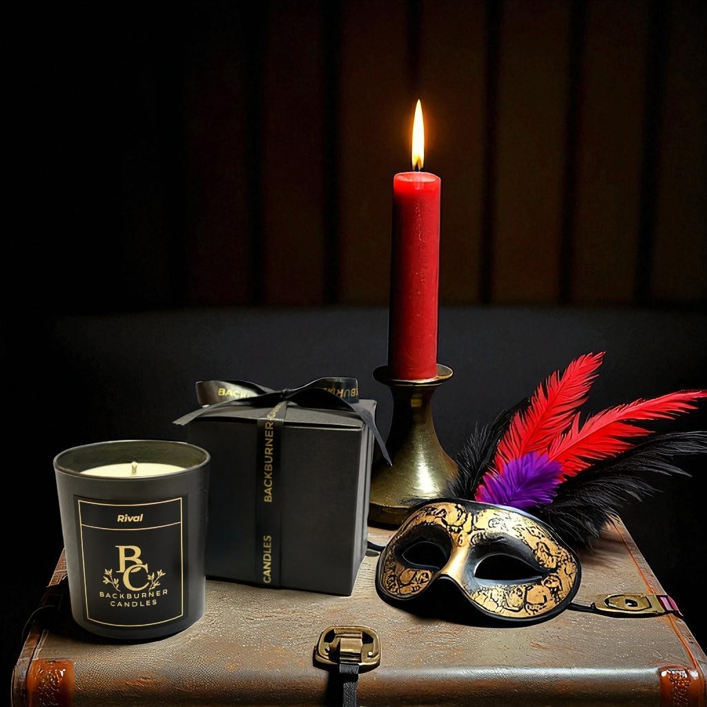 Backburner Candles Rival candle, gift box and decorative mask on a suitcase with a dark background