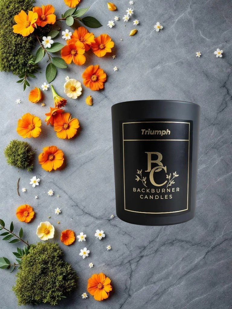 Backburner Candles Triumph candle in black jar with flowers and moss on marble – luxury and nature blend