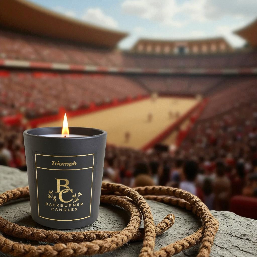 Backburner Candles Triumph candle lit on stone with rope, stadium backdrop – victory and ritual theme