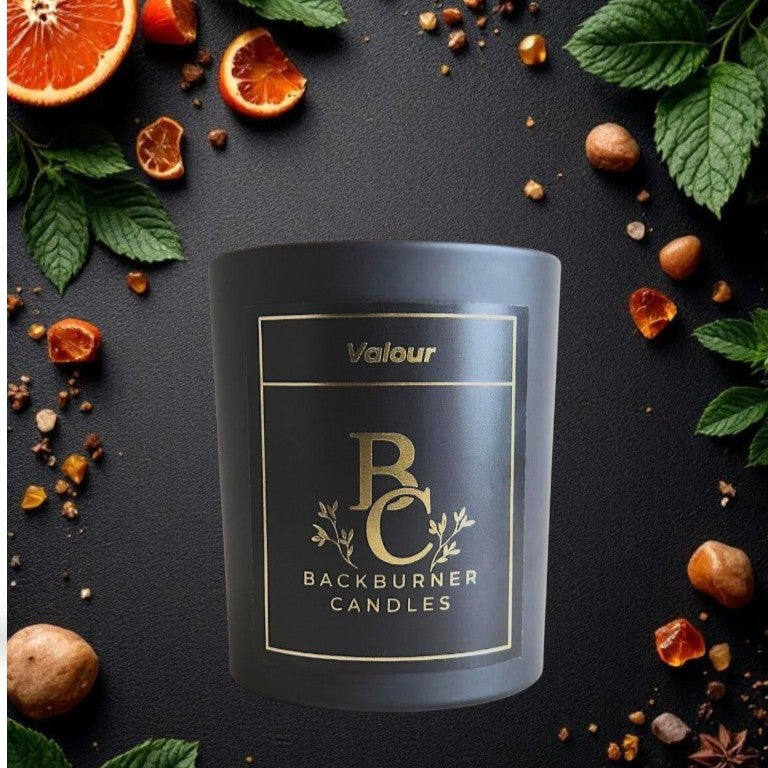 Valour Backburner Candles candle with decorative elements on a dark background