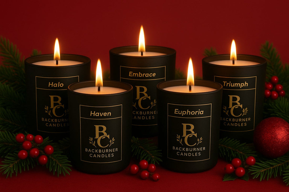 Five Backburner Candles grouped together with festive berries