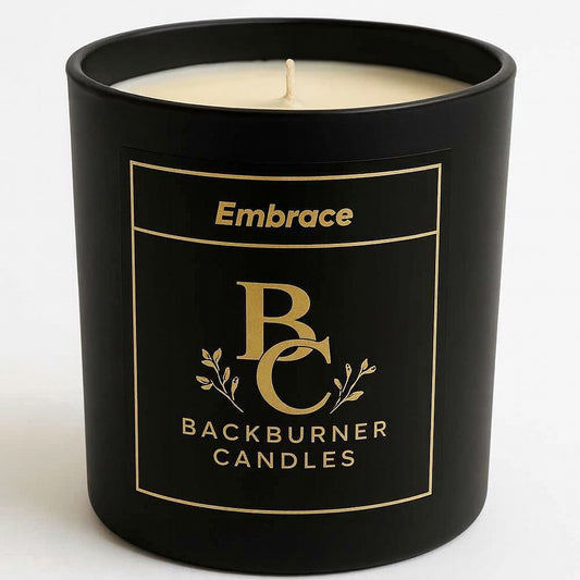 Black candle with 'Embrace Backburner Candles' label on a white background