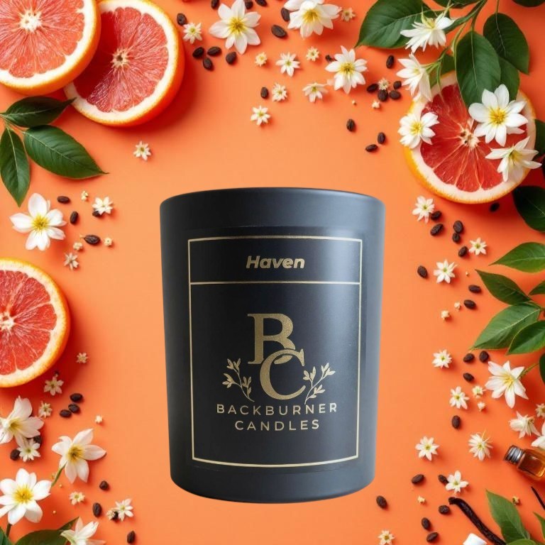 Black candle with 'Haven Backburner Candles' label on an orange background with sliced oranges and flowers.