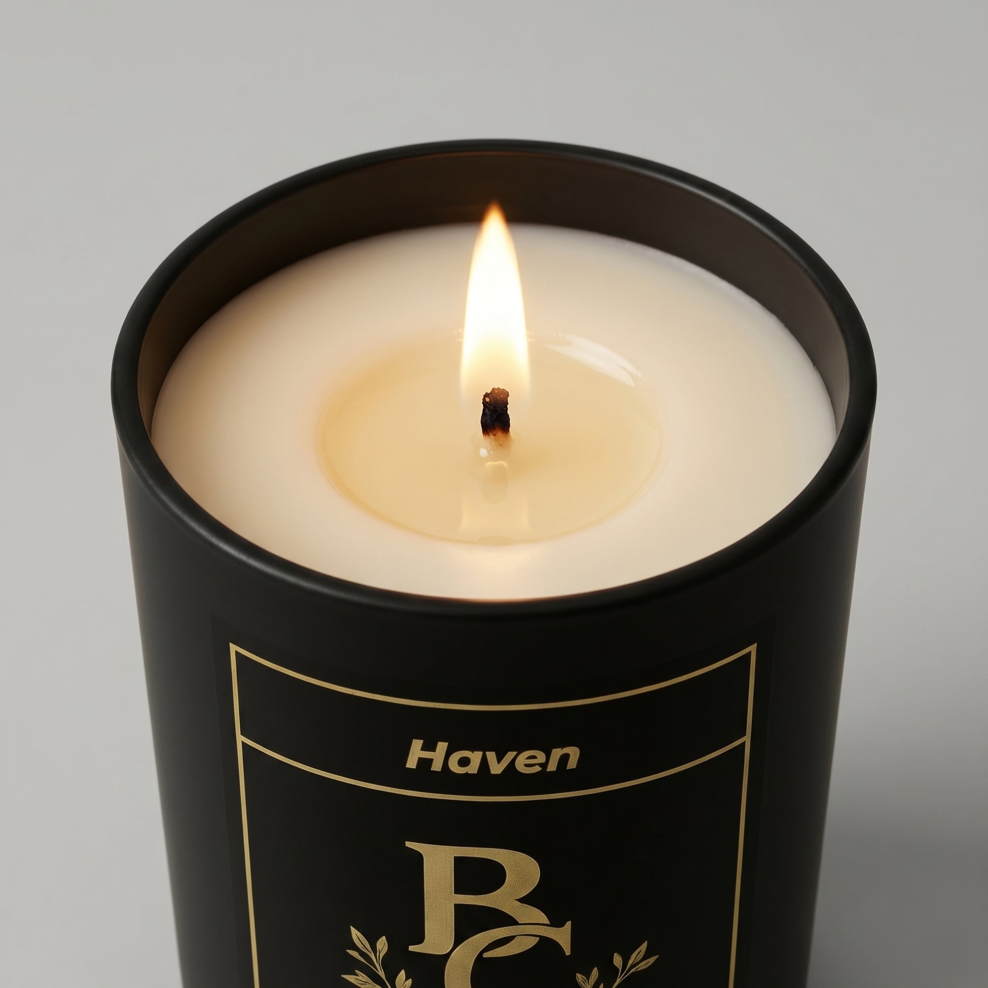 Candle in a black container labeled 'Haven' on a gray background
