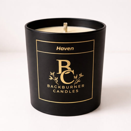 Black candle with 'Haven' and 'Backburner Candles' branding on a white background