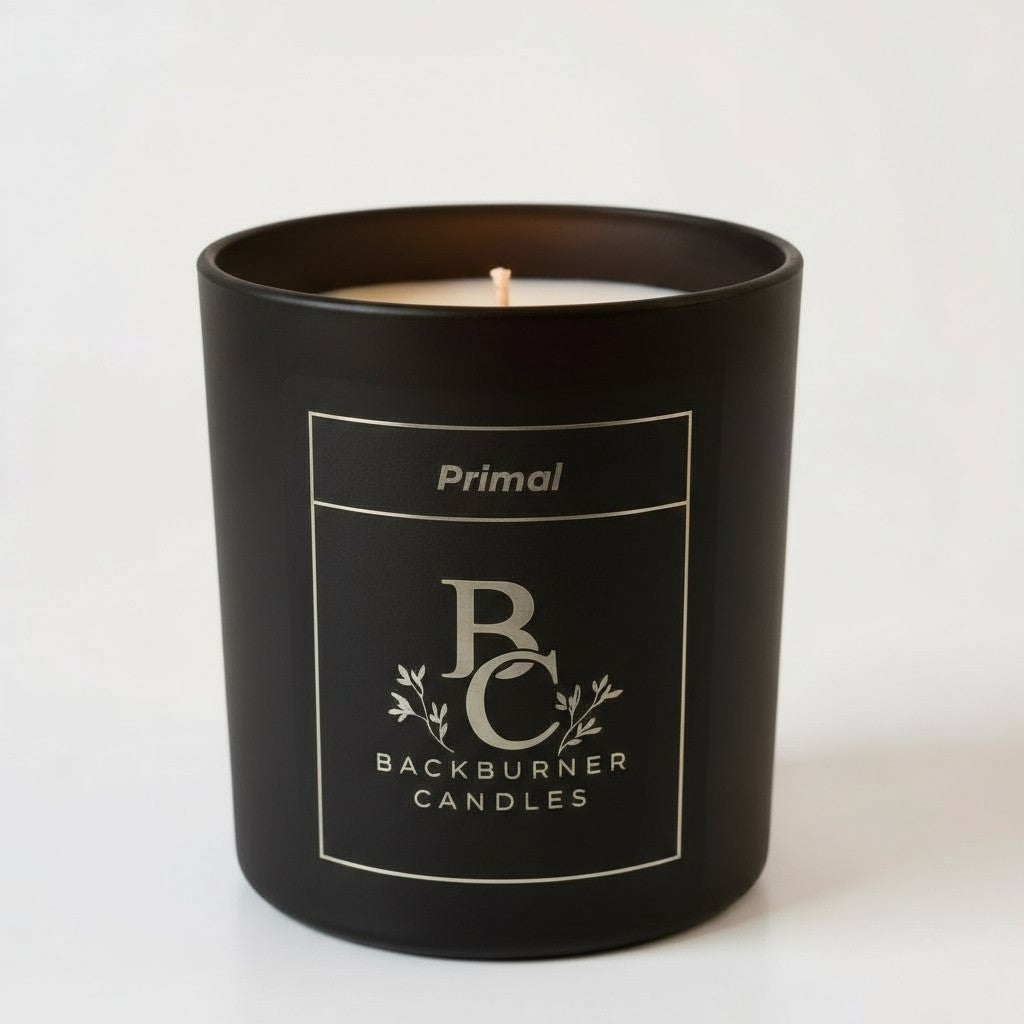 Unlit Primal vegan candle by Backburner Candles in black jar with gold logo and floral design, styled for a premium, elegant look.