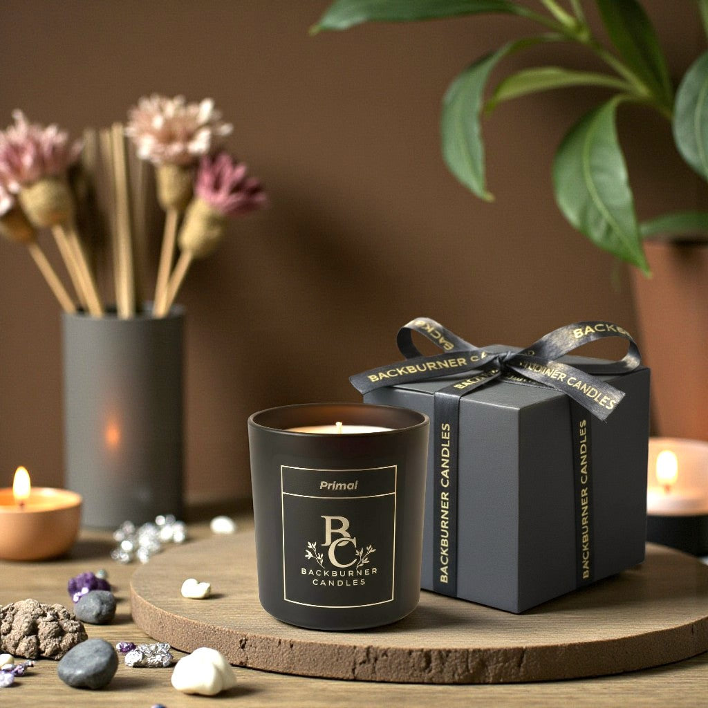 Backburner Candles candle and packaging on a wooden surface with decorative elements.