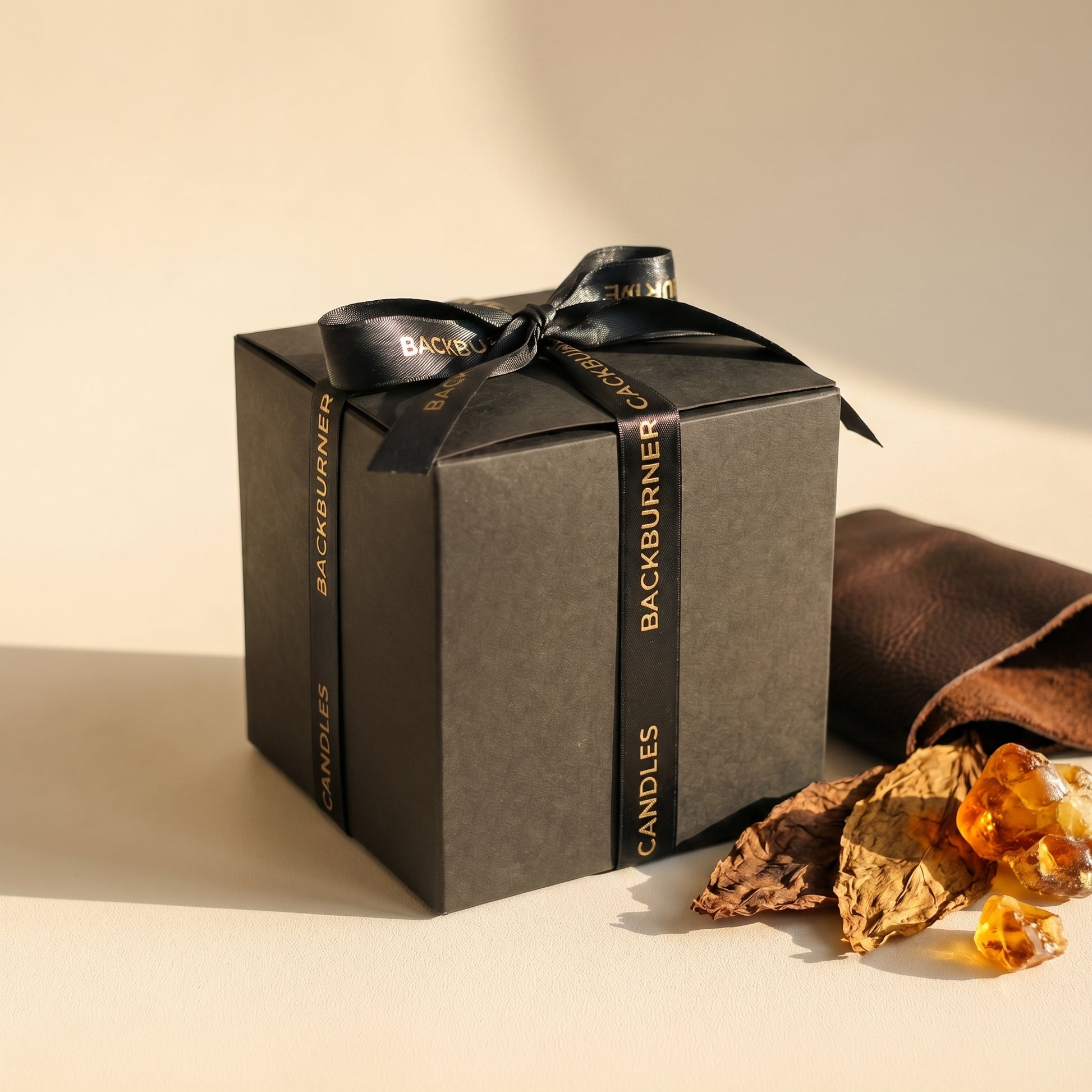 Gift box with 'Backburner' branding on a neutral background