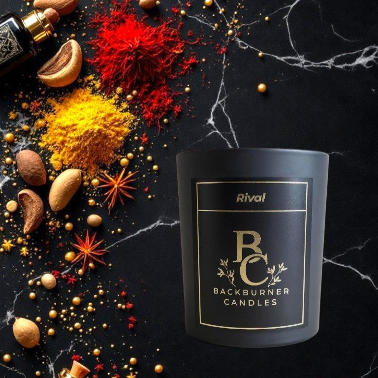 Backburner Candles candle with decorative spices and herbs on a dark marble surface