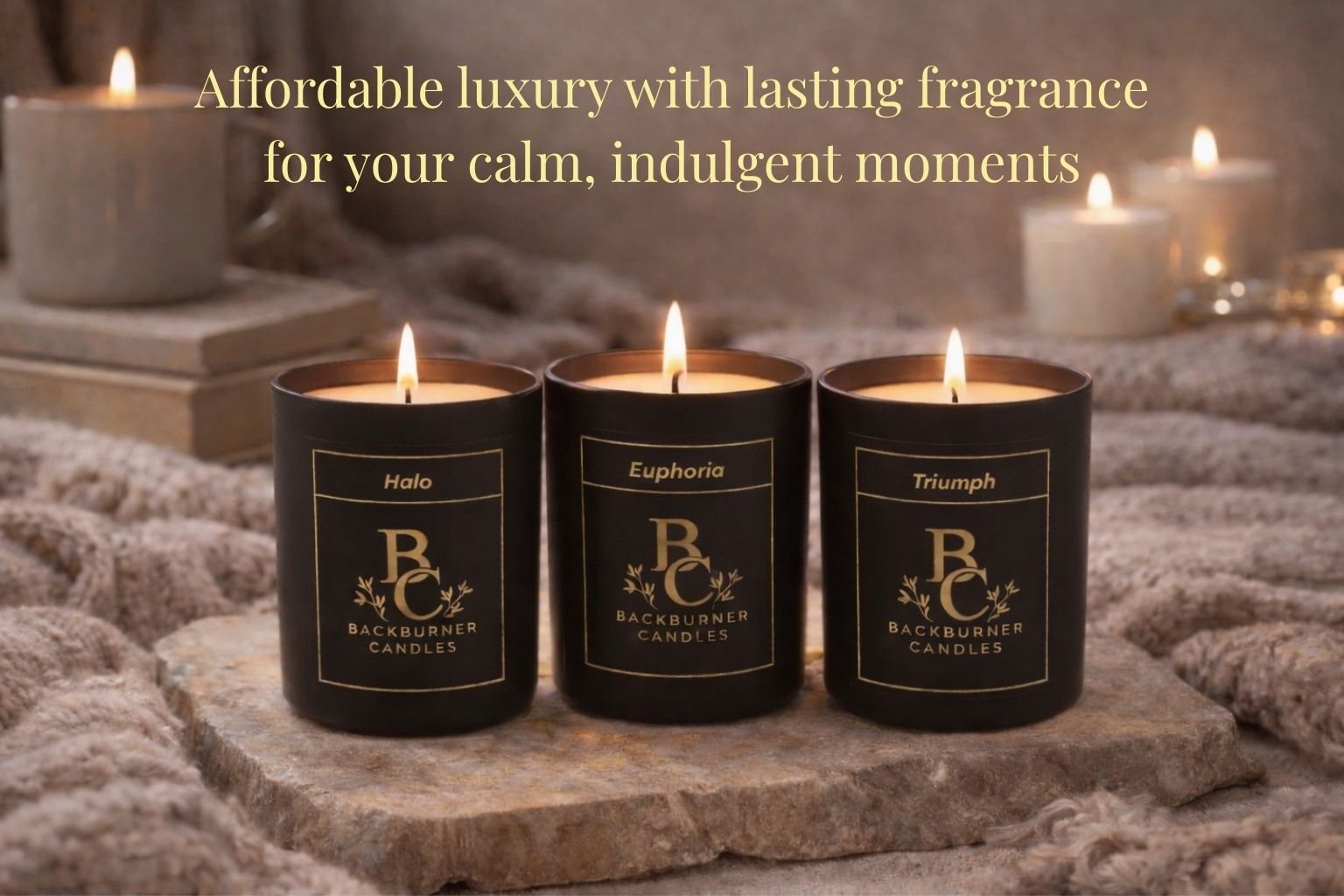 Three lit candles with labels on a stone surface, surrounded by soft lighting and textures.